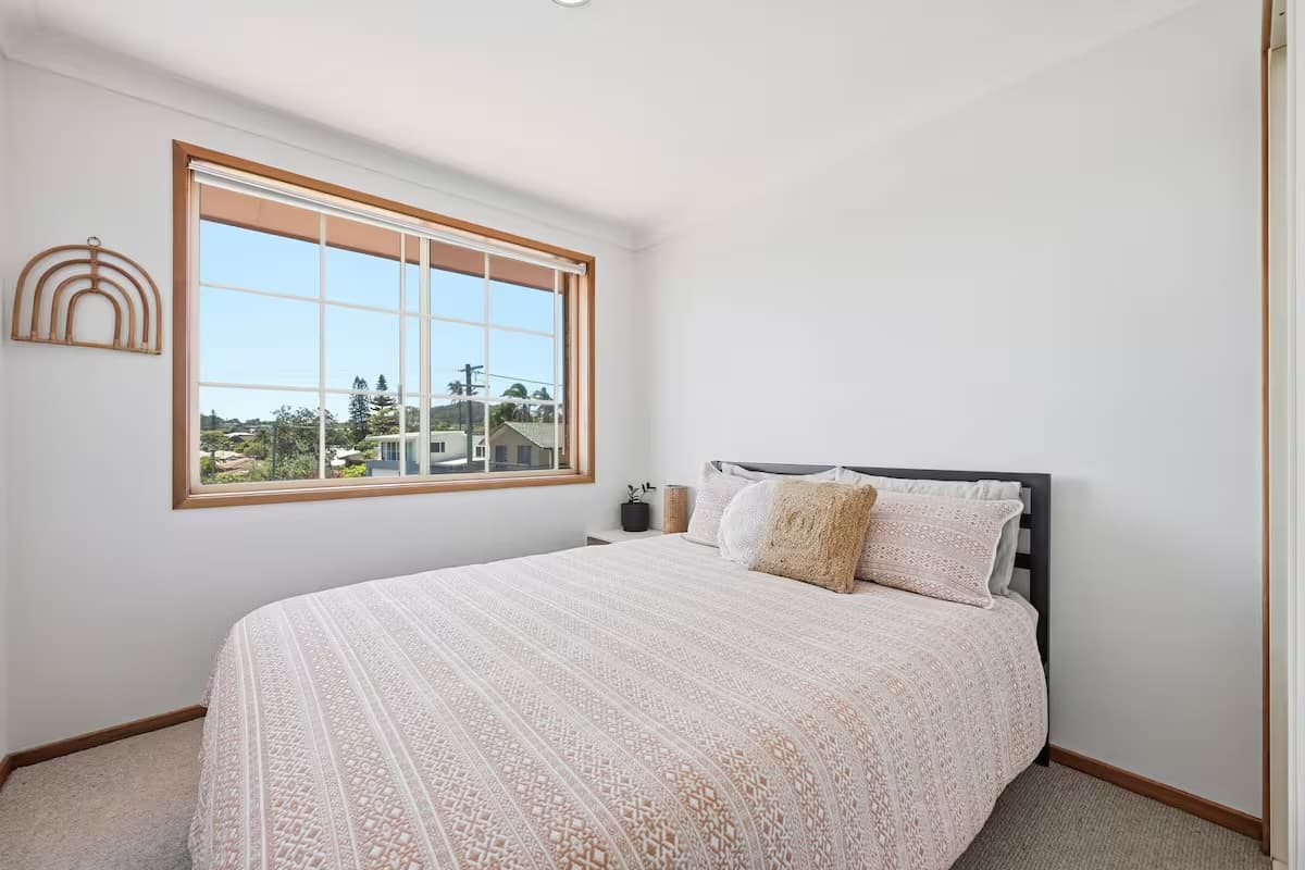 Bedroom 2 with a comfortable queen bed and leafy street views